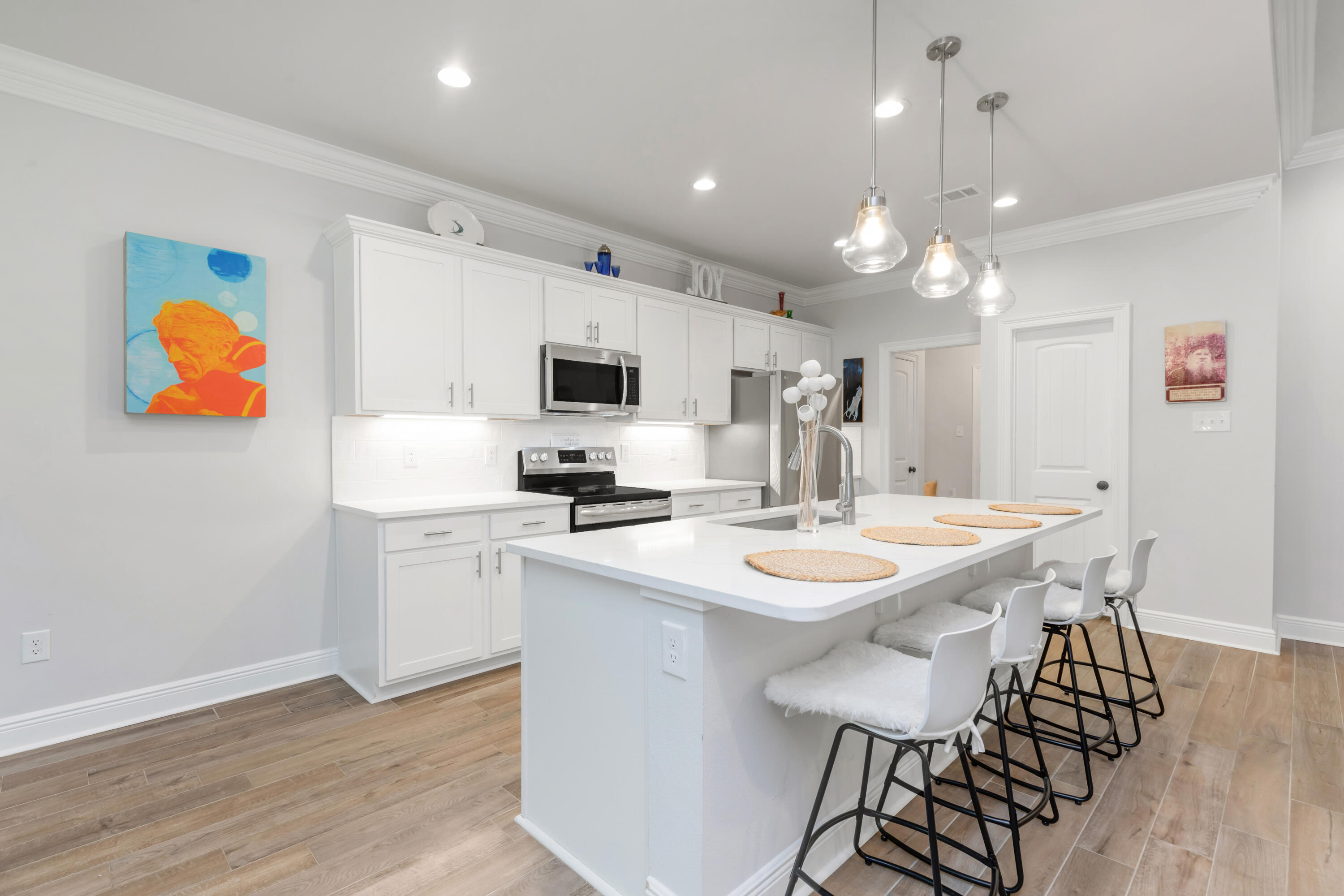 27 Cozy Cove Freeport, FL 32439 - Photo 11 of 80 a kitchen with stainless steel appliances kitchen island a white table chairs and a refrigerator