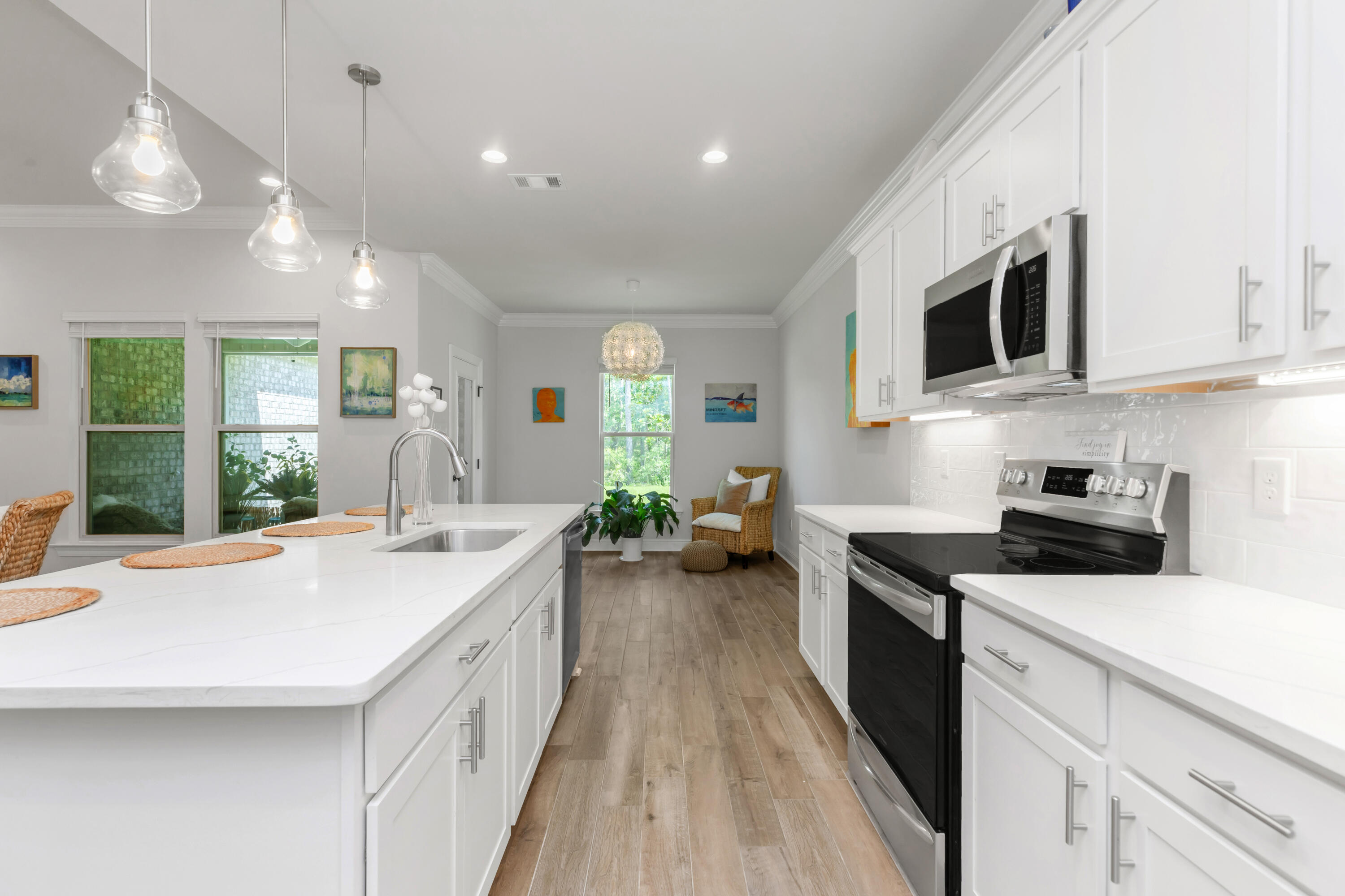 27 Cozy Cove Freeport, FL 32439 - Photo 15 of 80 a kitchen with stainless steel appliances a stove sink microwave and cabinets
