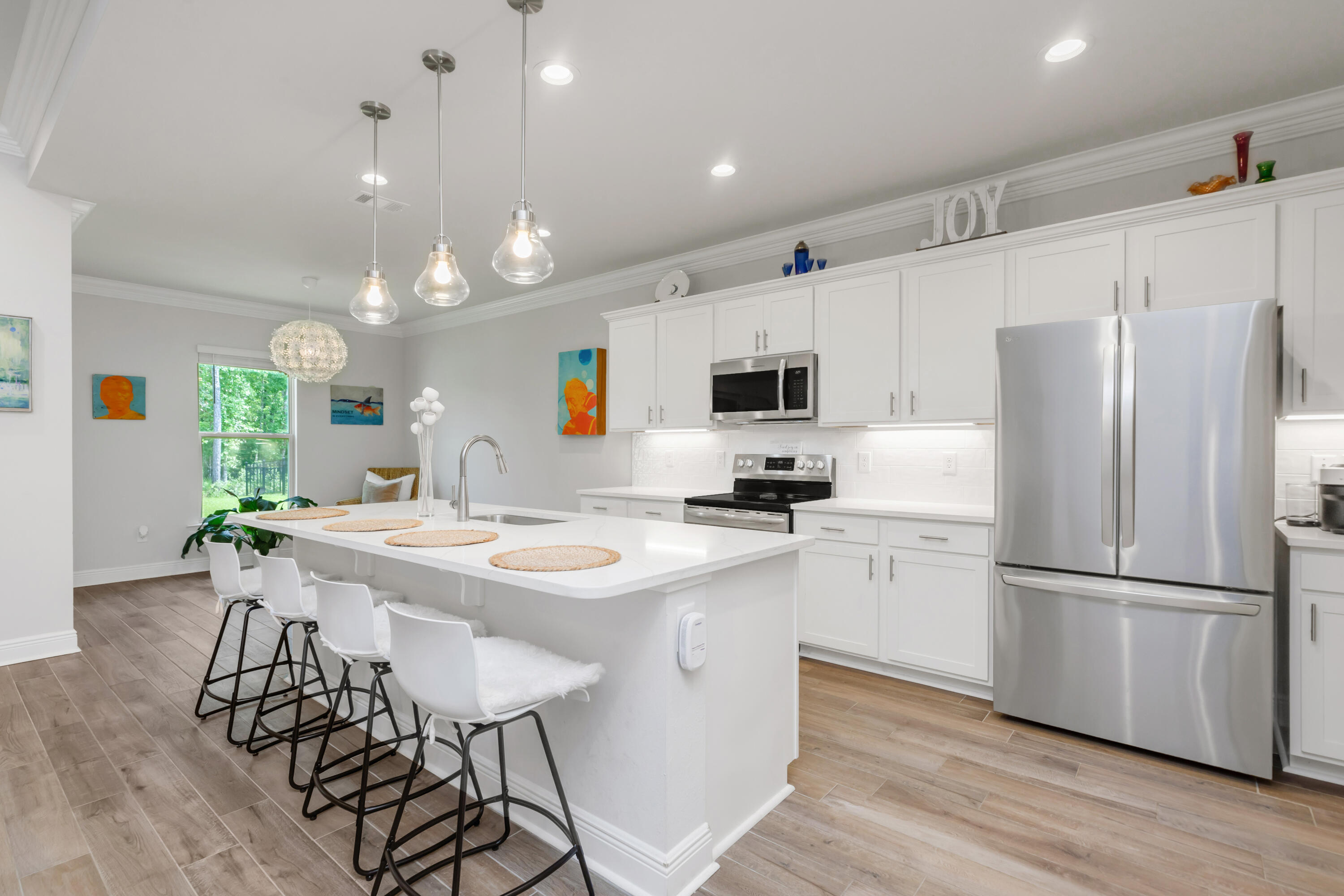 27 Cozy Cove Freeport, FL 32439 - Photo 16 of 80 a kitchen with stainless steel appliances a stove a sink dishwasher a refrigerator white cabinets and wooden floor