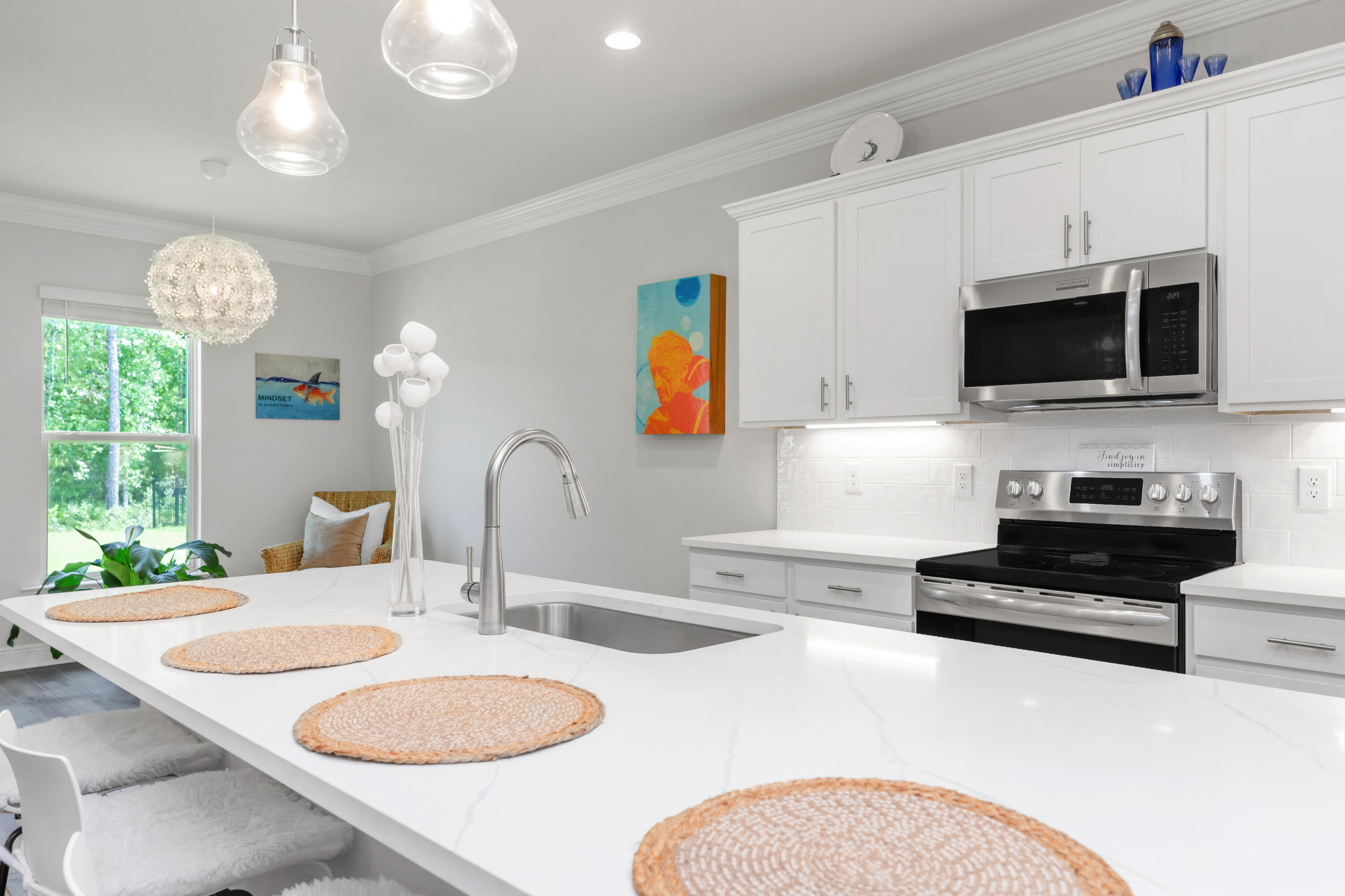 27 Cozy Cove Freeport, FL 32439 - Photo 17 of 80 a kitchen with stainless steel appliances granite countertop a sink a microwave cabinets and a dining table