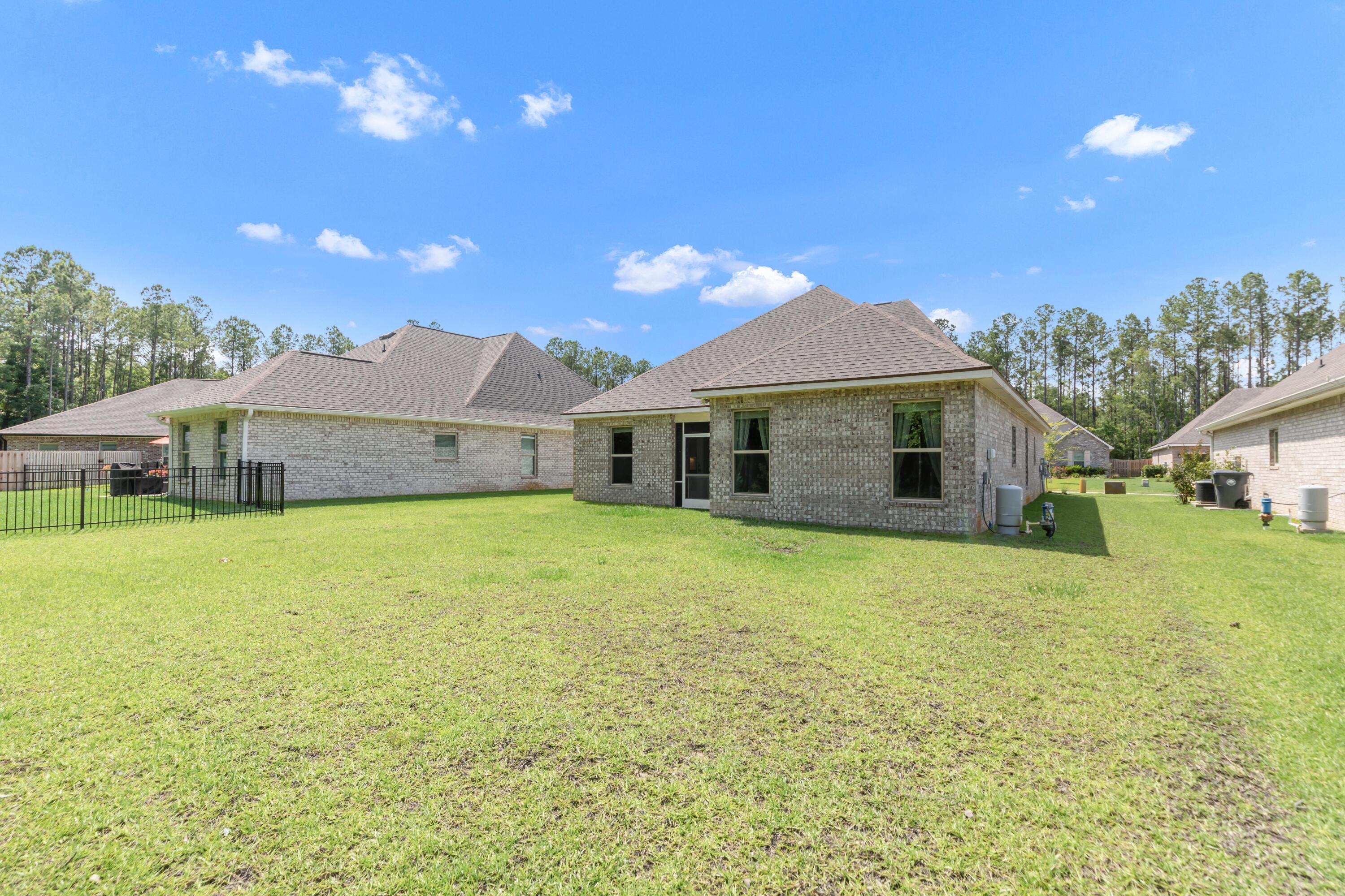 27 Cozy Cove Freeport, FL 32439 - Photo 46 of 80 a front view of a house with a garden and yard