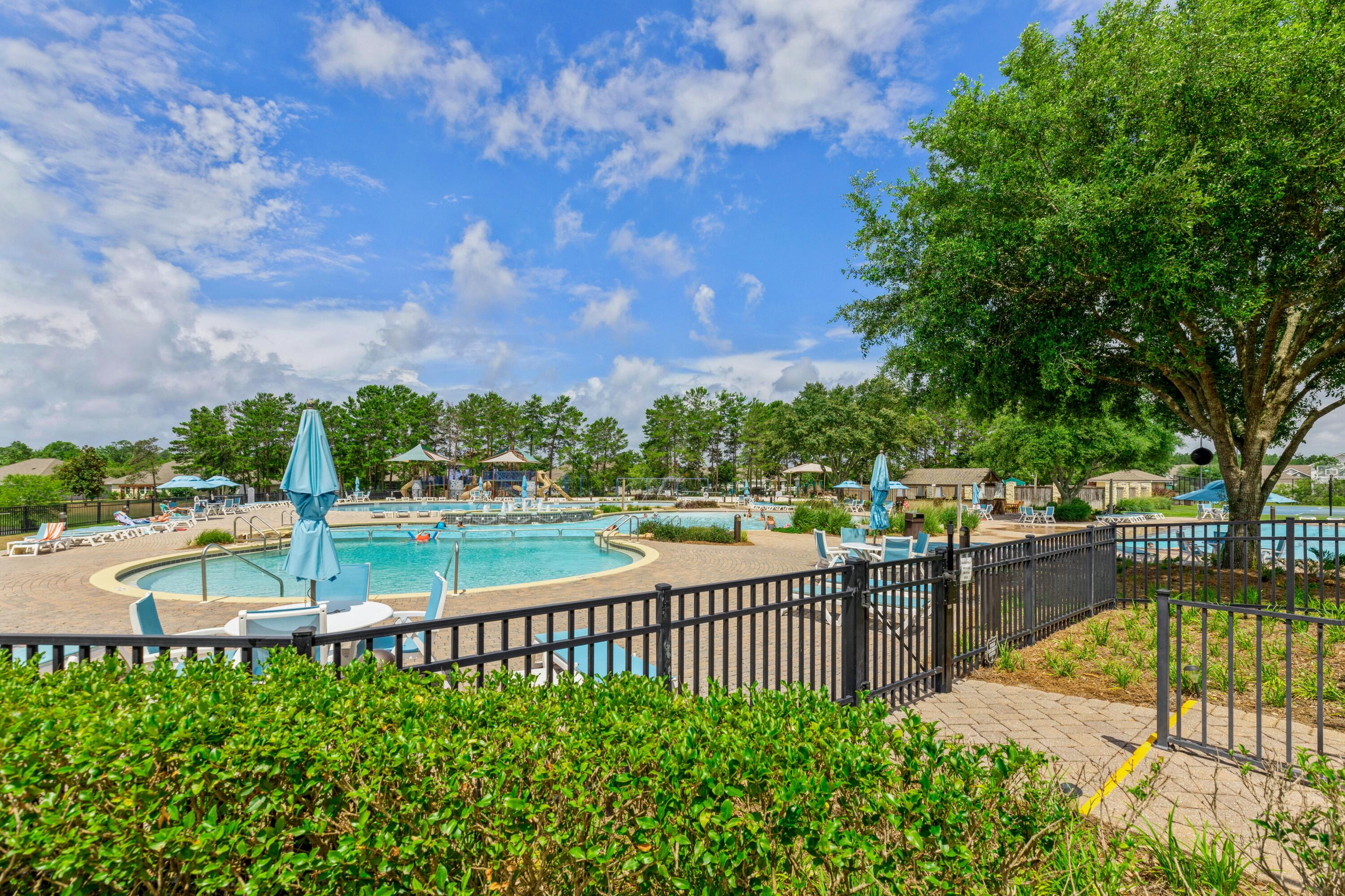 27 Cozy Cove Freeport, FL 32439 - Photo 65 of 80 a view of a swimming pool with a patio and a garden