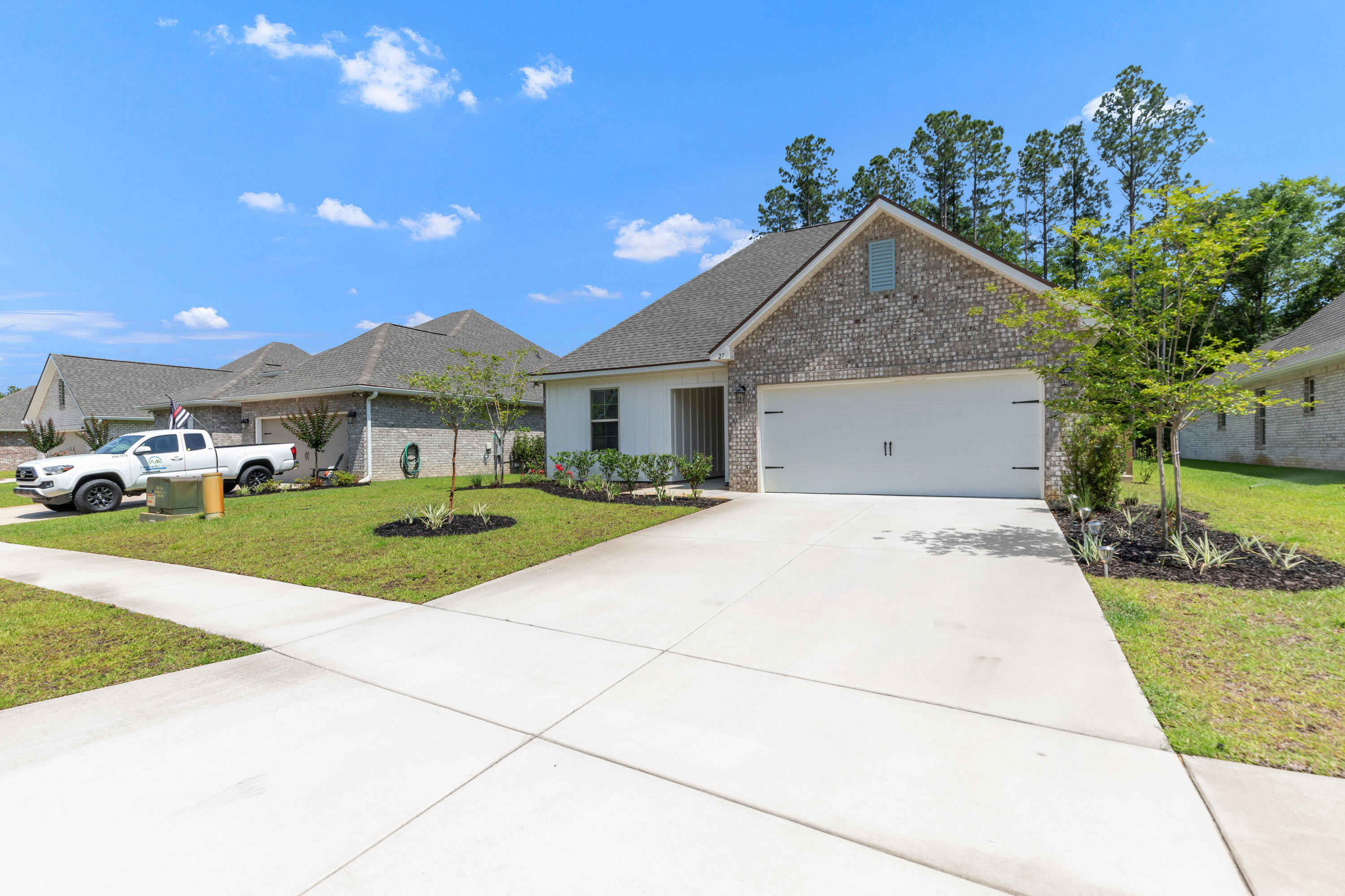 27 Cozy Cove Freeport, FL 32439 - Photo 80 of 80 a front view of a house with a yard and garage