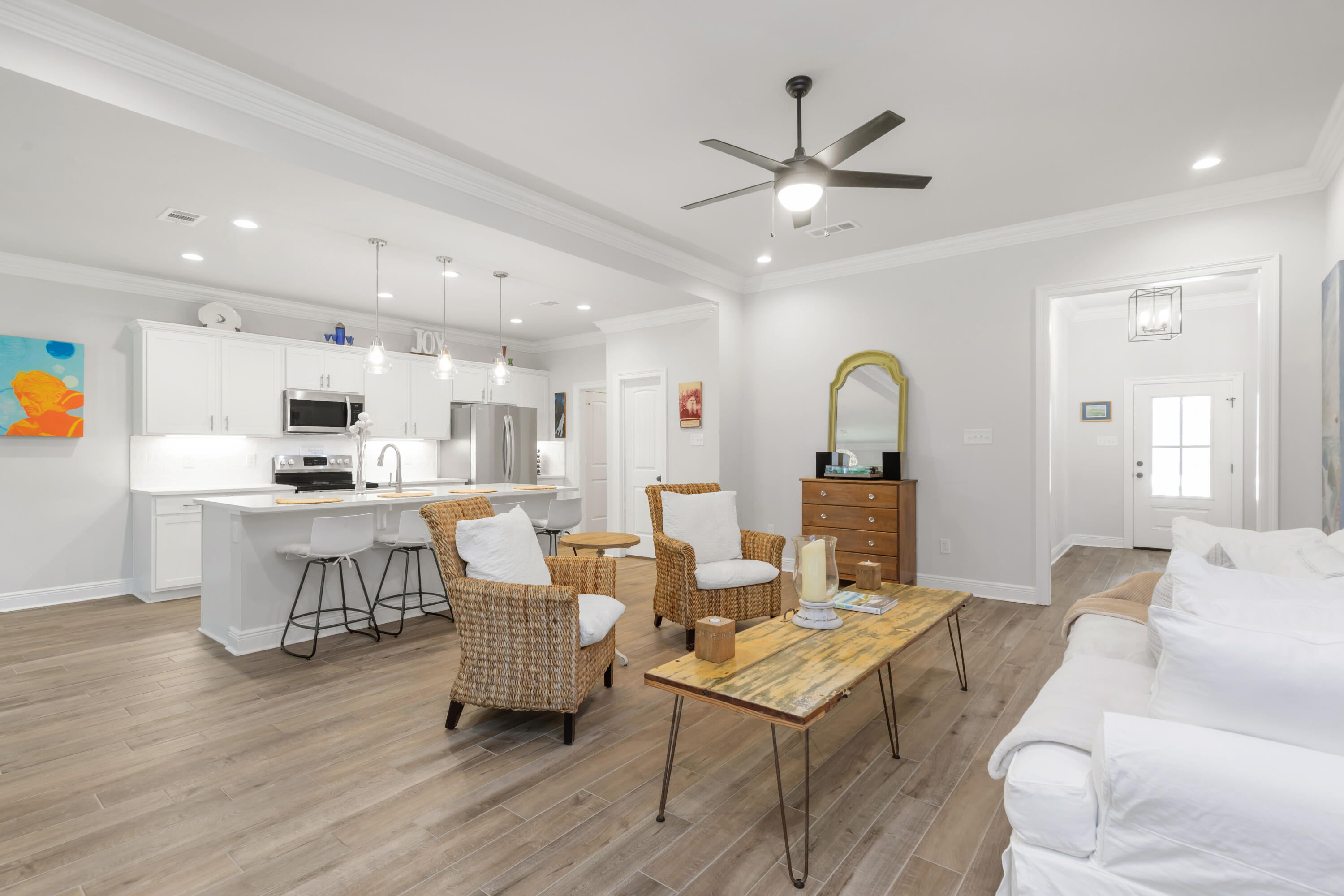 27 Cozy Cove Freeport, FL 32439 - Photo 10 of 80 a living room with couches a dining table and kitchen view with wooden floor
