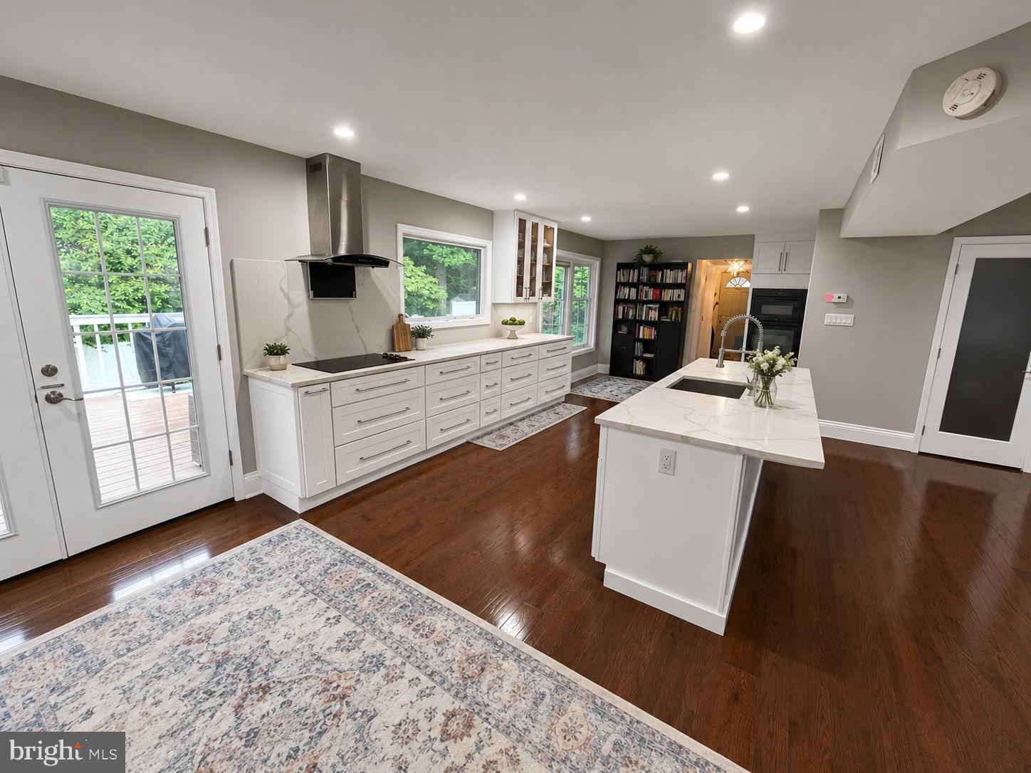 1639 Winding Waye Lane Silver Spring, MD 20902 - Photo 2 of 17 a large white kitchen with wooden floor and a sink