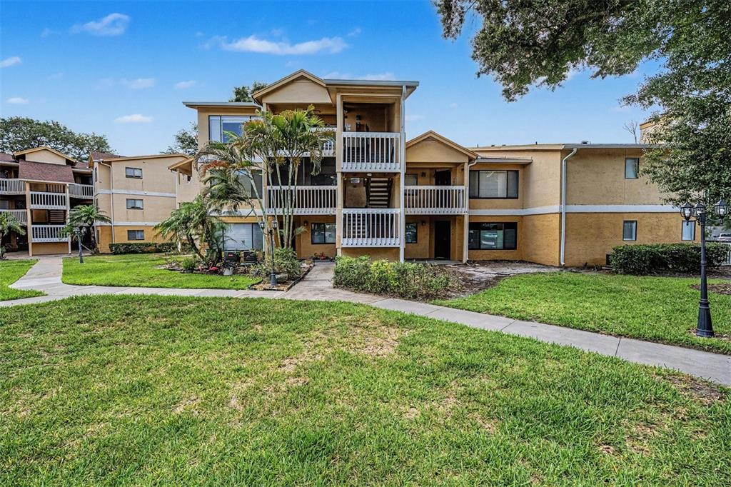 1550 South Belcher Road, Unit 525 Clearwater, FL 33764 - Photo 22 of 28 a front view of a house with a yard and trees