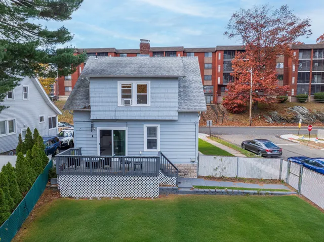 a view of a house with a yard porch and sitting area