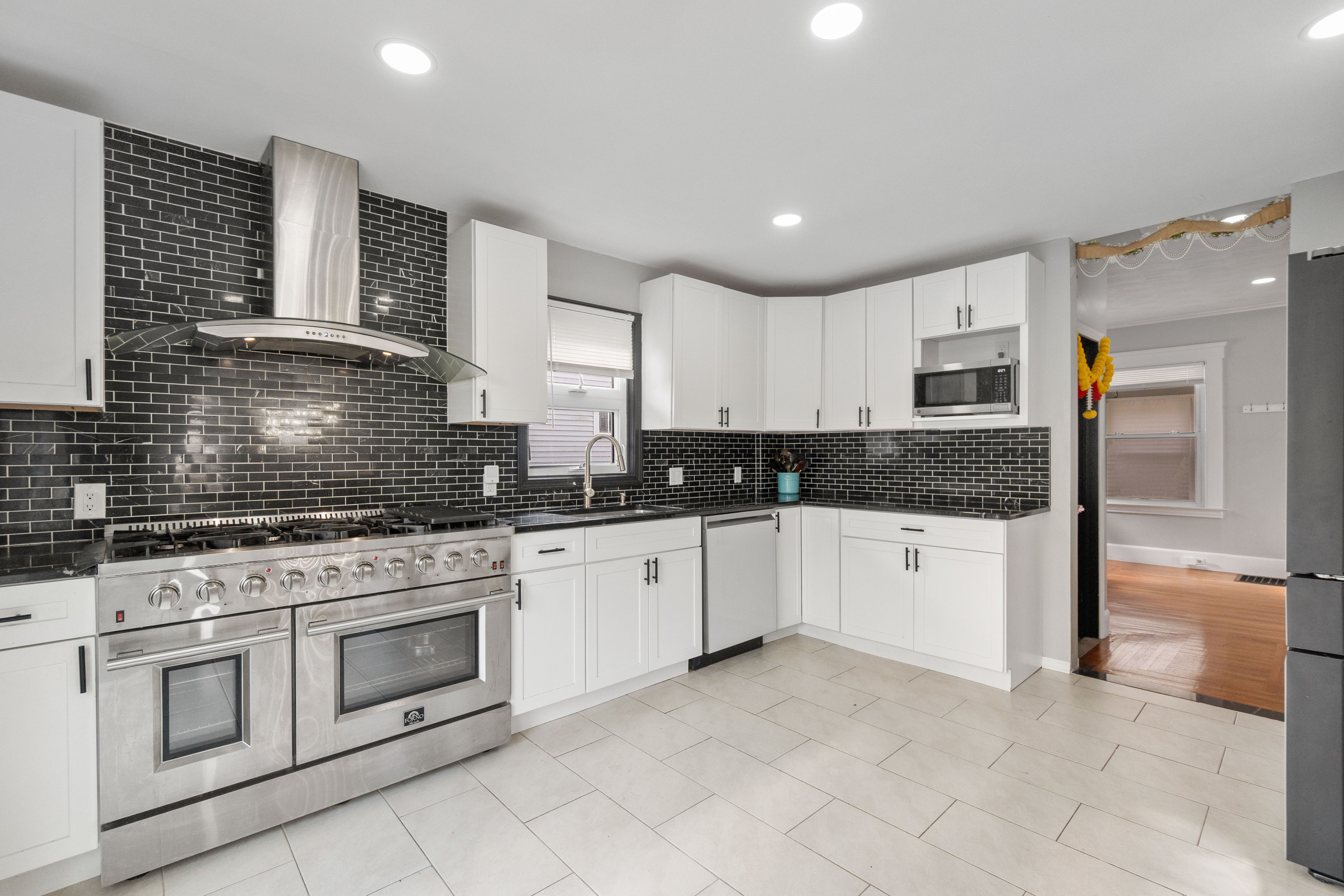 481 Savin Avenue West Haven, CT 06516 - Photo 2 of 21 a kitchen with granite countertop white cabinets and white appliances
