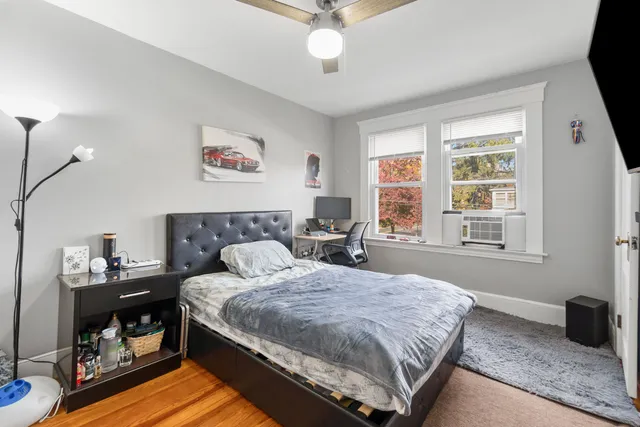 a bedroom with a bed and a window