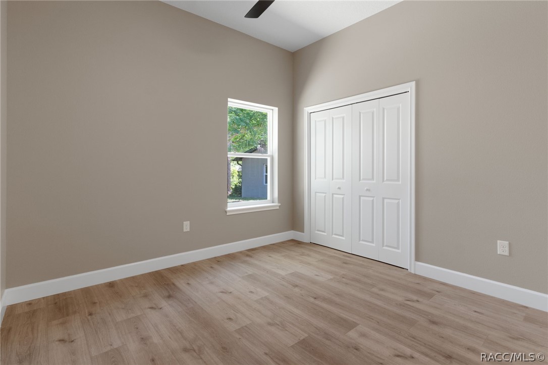 4530 South Florida Avenue Inverness, FL 34450 - Photo 34 of 100 a view of an empty room with wooden floor and a window