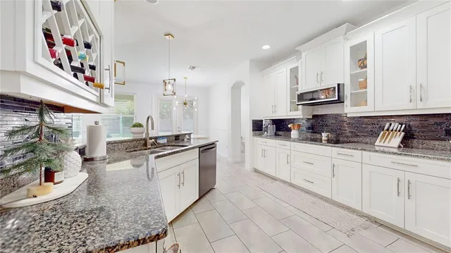 a kitchen with stainless steel appliances granite countertop a sink and cabinets