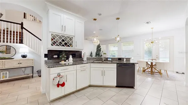 a kitchen with stainless steel appliances granite countertop a sink and cabinets
