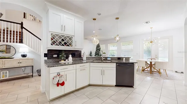 a kitchen with stainless steel appliances granite countertop a sink and cabinets
