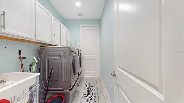a utility room with wooden floor washer and dryer