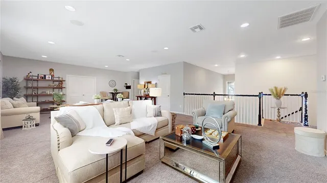 a living room with furniture and a view of kitchen