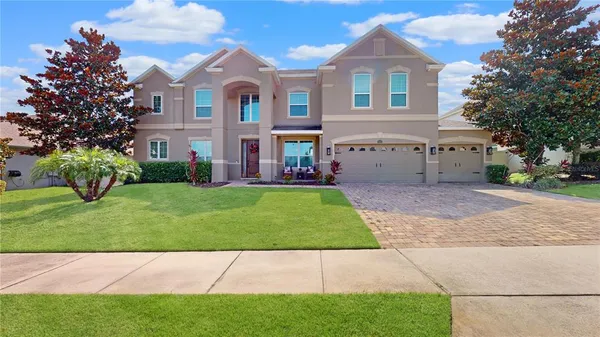 a front view of a house with a garden and yard