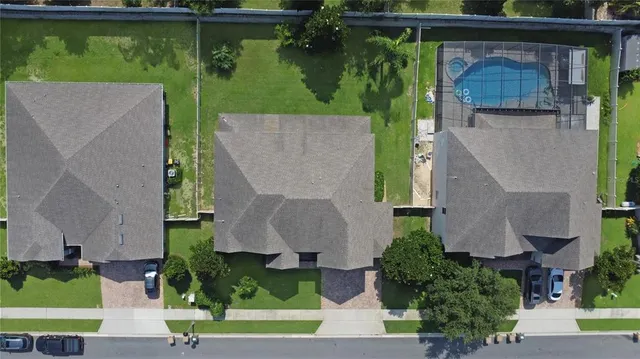 an aerial view of a house with a yard basket ball court and outdoor seating