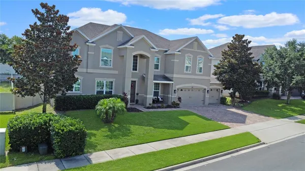 a front view of a house with a garden and plants