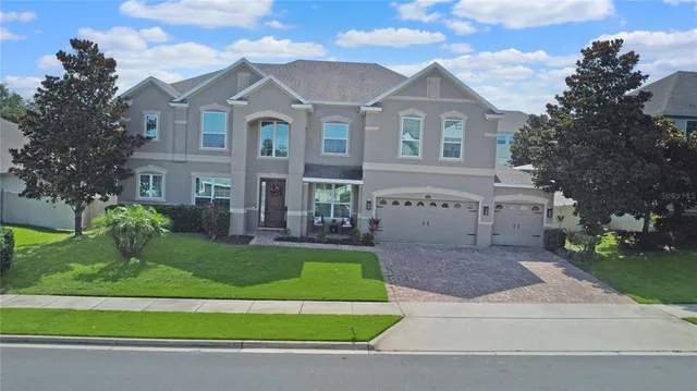 a front view of a house with a garden and plants