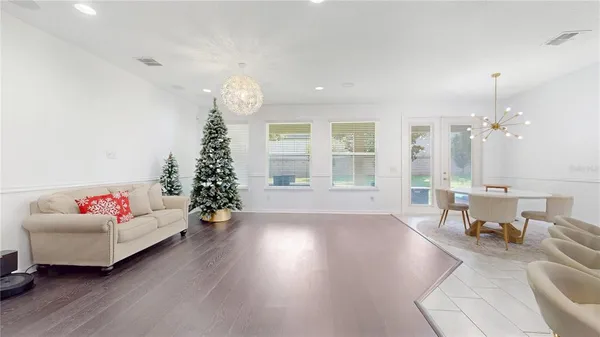 a living room with furniture and a chandelier