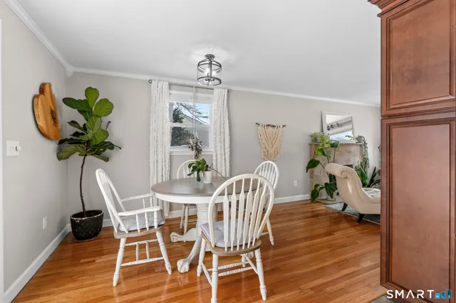 a view of a dining room with furniture wooden floor and a chandelier