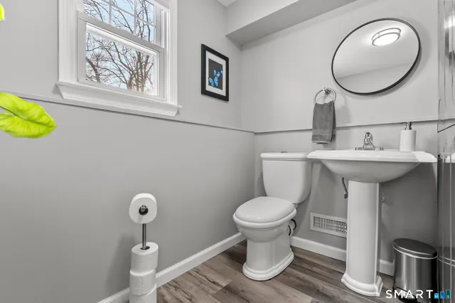 a bathroom with a toilet sink and mirror