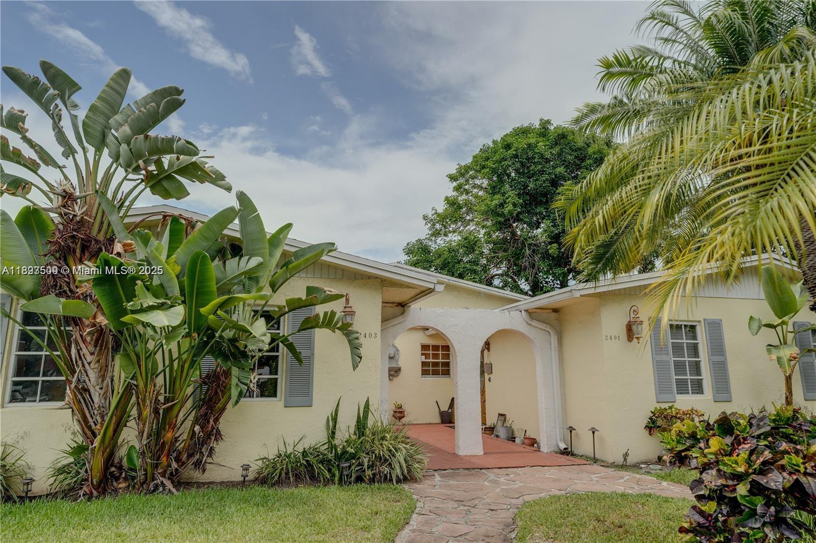 a front view of a house with a garden