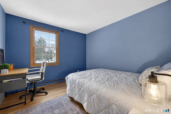 a bedroom with a bed a desk and chair