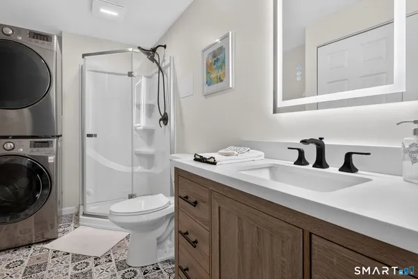 a bathroom with a sink toilet and shower