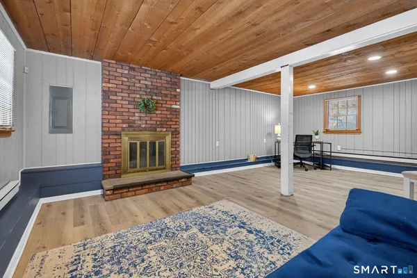 a view of a livingroom with wooden floor and furniture