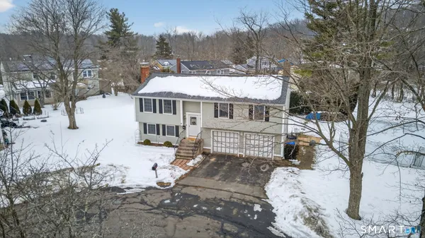 a view of a house with a yard covered in snow