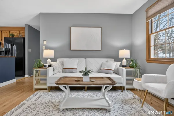 a living room with furniture a rug and a table