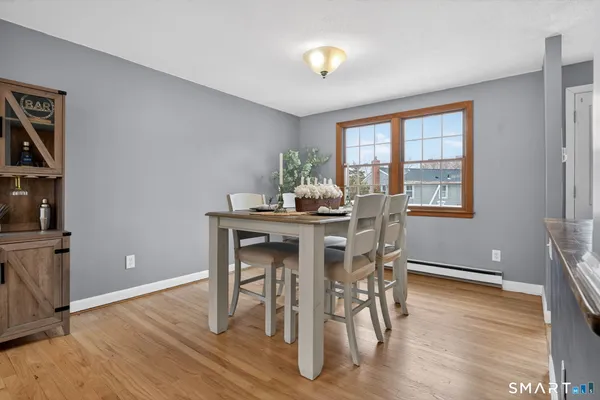 a dining room with furniture and wooden floor