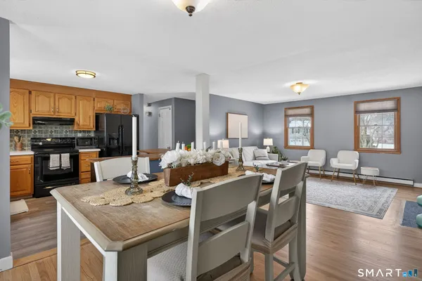 a view of a dining room with furniture and wooden floor