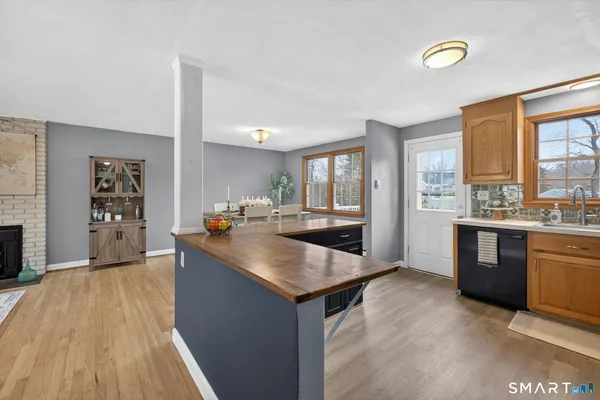 a large kitchen with kitchen island a sink wooden floor and counter top space