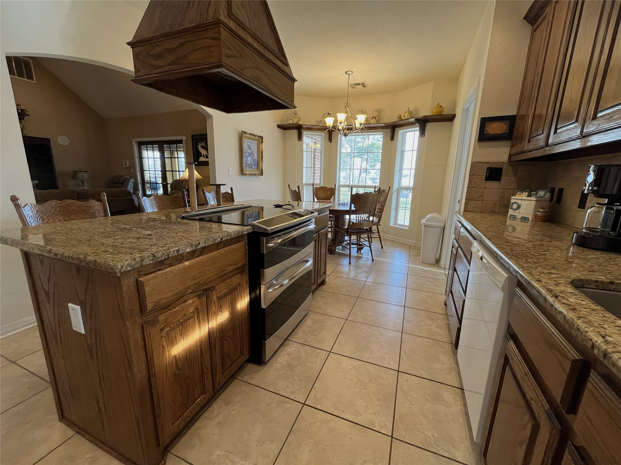 19846 Post Oak Loop Thornton, TX 76687 - Photo 19 of 44 a kitchen with stainless steel appliances granite countertop a stove a sink and a microwave