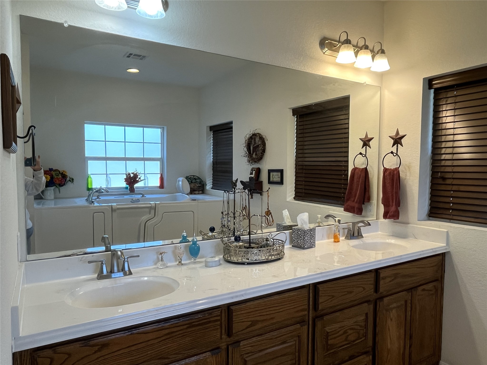 19846 Post Oak Loop Thornton, TX 76687 - Photo 31 of 44 a bathroom with double vanity sinks a vanity and a mirror