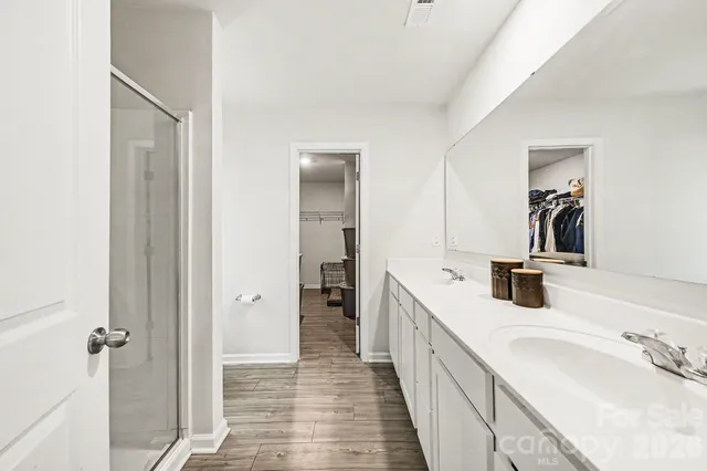 a bathroom with a double vanity sink and mirror
