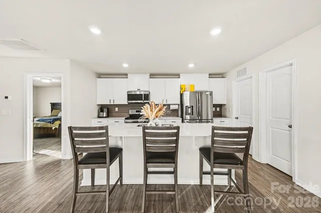 a kitchen with kitchen island wooden cabinets and stainless steel appliances