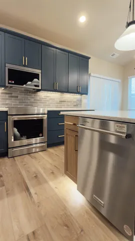a kitchen with granite countertop a stove and a sink