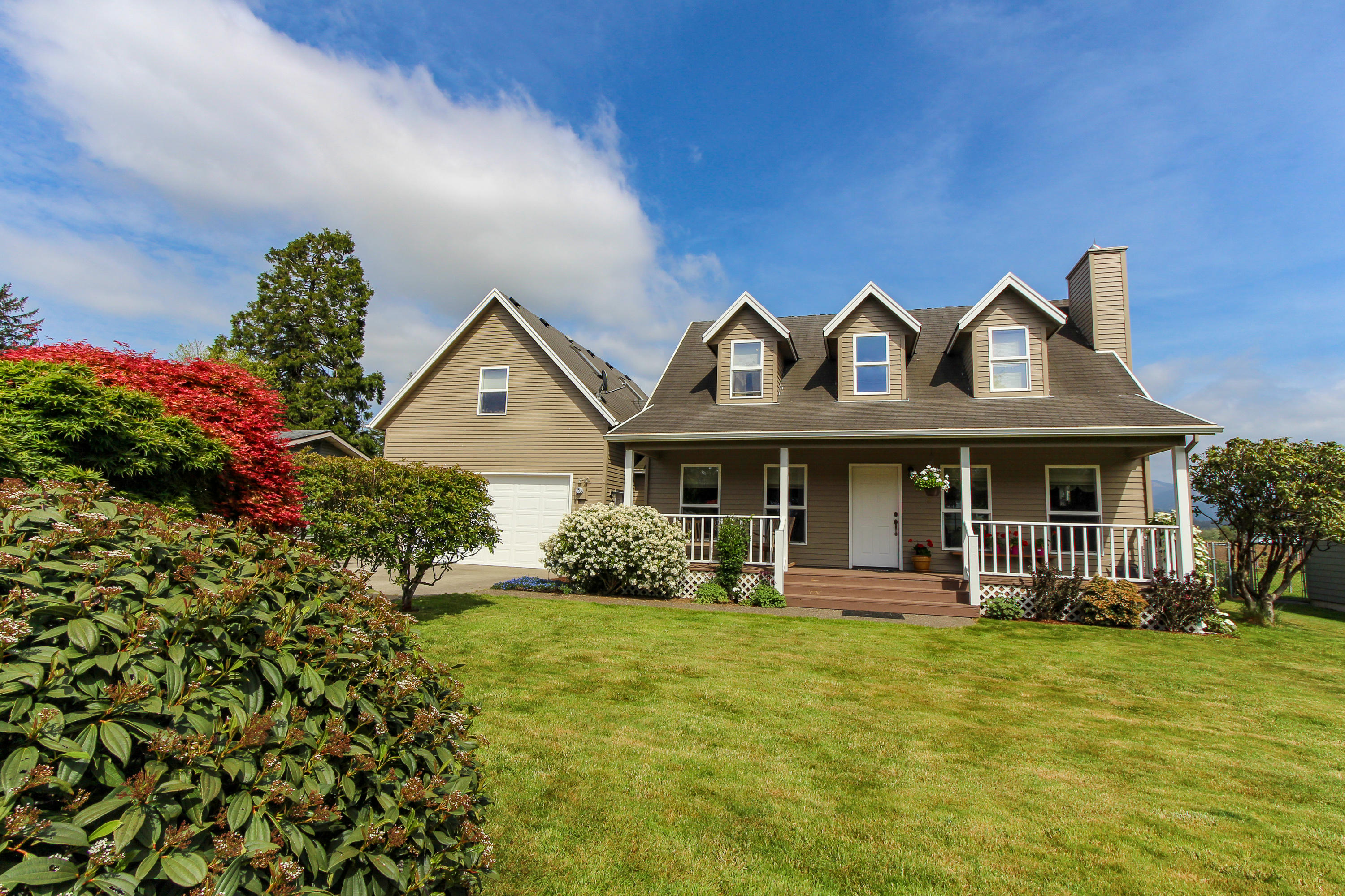 3225 Fitzpatrick Road Tillamook, OR 97141 - Photo 1 of 50 a front view of a house with garden