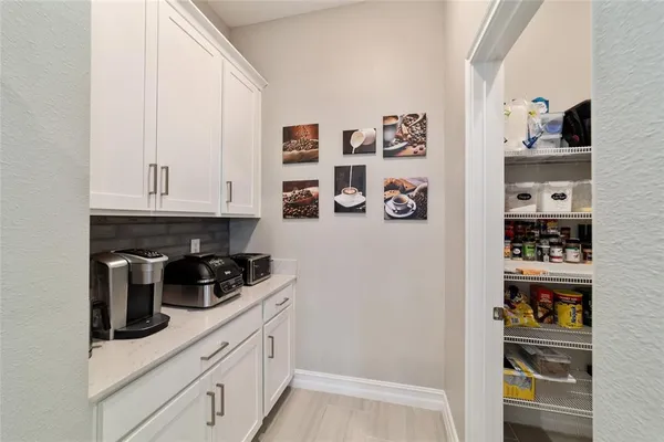 a kitchen with a refrigerator and cabinets