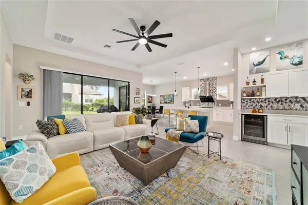 a living room with furniture kitchen view and a fireplace