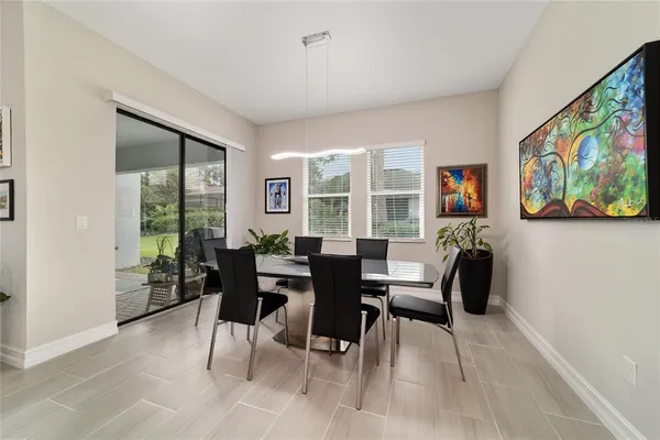 a dining room with furniture a rug and wooden floor