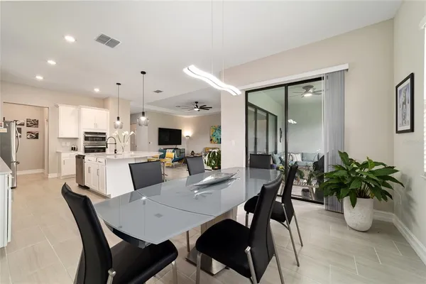 a large kitchen with a table and chairs