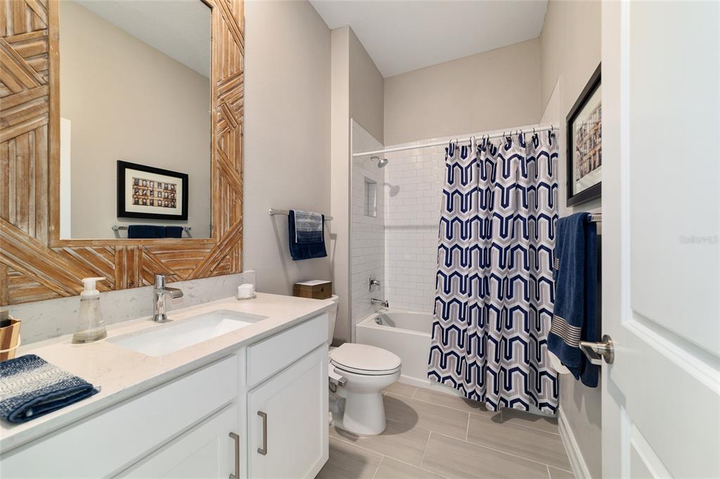 906 Southeast 41st Street Ocala, FL 34480 - Photo 27 of 37 a bathroom with a granite countertop sink toilet and shower