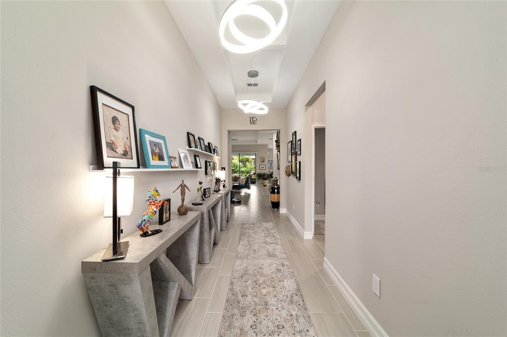 906 Southeast 41st Street Ocala, FL 34480 - Photo 3 of 37 a view of a hallway with workspace and living room