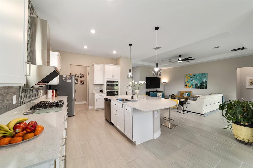 906 Southeast 41st Street Ocala, FL 34480 - Photo 7 of 37 a open kitchen with stainless steel appliances kitchen island granite countertop a stove and a sink