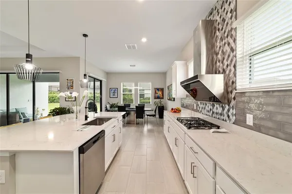 a kitchen with counter top space a stove and a window