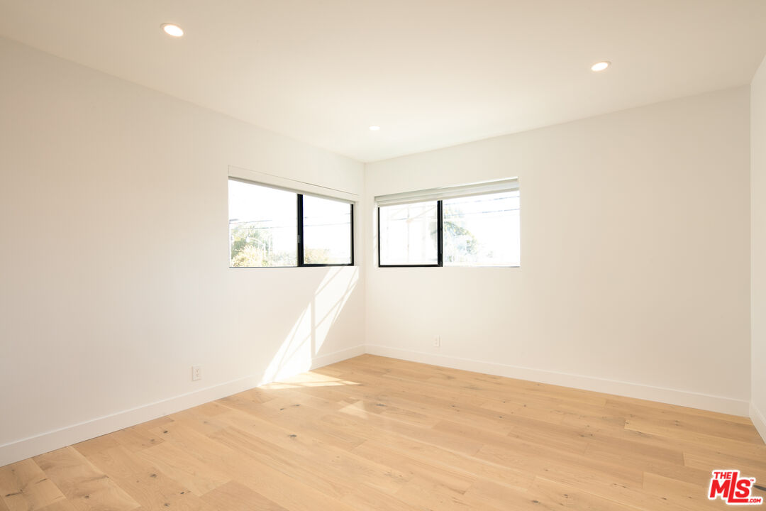 2811 3rd Street, Unit 1 Santa Monica, CA 90405 - Photo 12 of 21 an empty room with wooden floor and windows